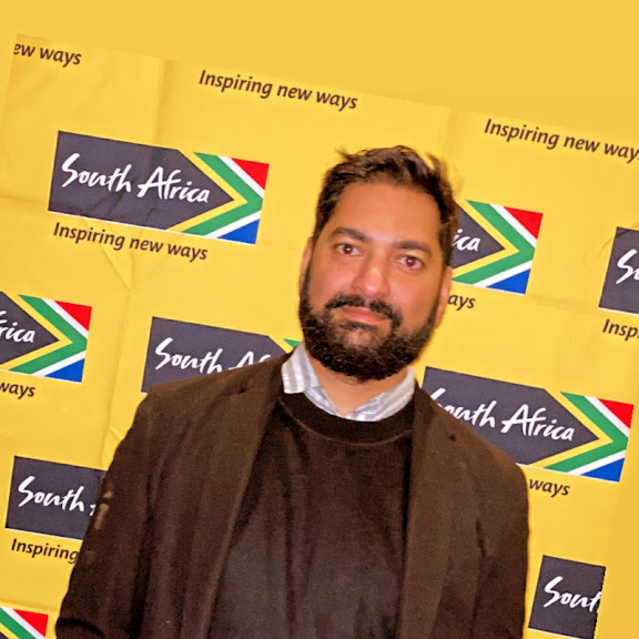 Head Shot of Sira Naidu in front of South Africa Backdrop